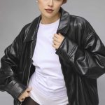 Fashion model with short auburn wig wearing leather jacket and white t-shirt.