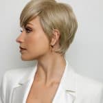 Short blonde wig styled in a layered pixie cut for a modern look.