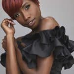 Elegant woman with short red wig from Hidden Secrets Wigs for stylish looks.