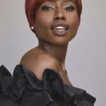 Elegant short red wig styled on a confident woman for a sophisticated look.