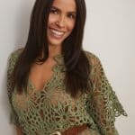 Beautiful woman with long, dark hair wearing a green lace dress.