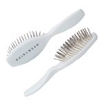 Oval wire wig brush for styling and detangling wigs and hairpieces.