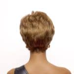 Back view of a woman with short, layered, light brown wig.