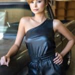 Fashion model with short hairstyle in black outfit at Hidden Secrets Wigs.