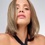 Woman with shoulder-length blonde hair wearing a natural-looking wig topper.