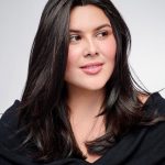 Woman with long, dark, natural-looking hair topper from Hidden Secrets Wigs.