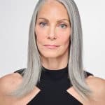 Elegant gray-haired woman wearing a natural-looking wig topper.