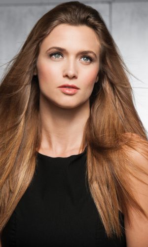 Woman with long, straight, light brown hair and blue eyes.