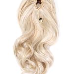 Blonde wavy hair extension with claw clip and elastic band.