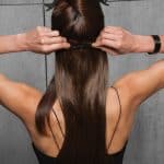 Applying 20in straight clip-in human hair extensions for a natural look.