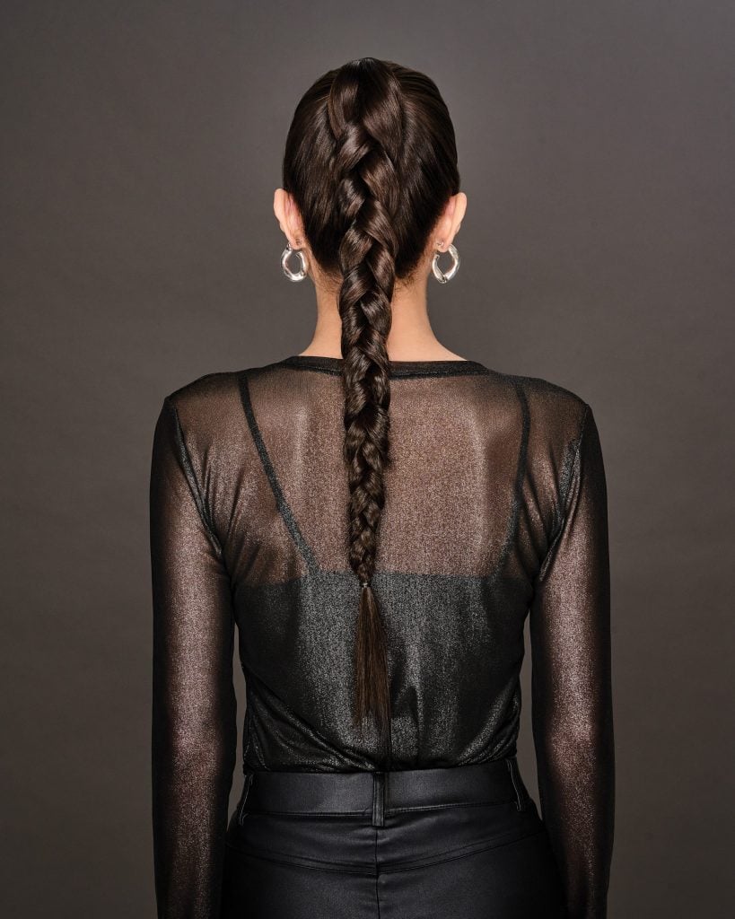 Back view of a woman with a braided ponytail hairstyle from Hidden Secrets Wigs.