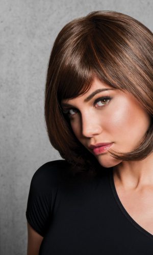 Woman with short brown bob wig and side-swept bangs.
