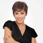 Woman with short, layered pixie wig in a professional style.