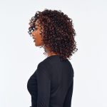 Curly wig with reddish-brown highlights on a woman in profile.