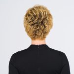 Back view of a woman with a short, curly, blonde wig.
