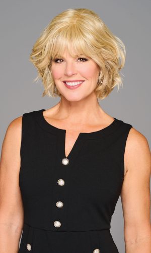 Blonde woman with short, wavy beach waves hairstyle and black sleeveless dress.
