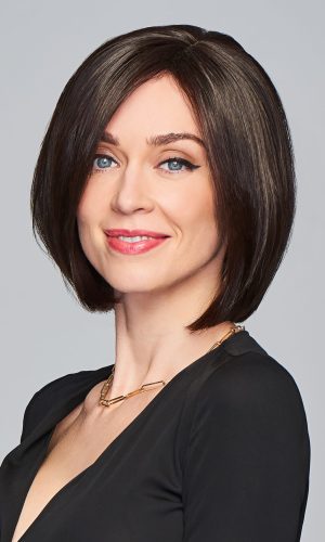 Woman with a sleek, short bob wig in dark brown, smiling confidently.