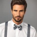 Stylish man with well-groomed hair and bow tie for elegant look.