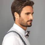 Side profile of a man with well-groomed hair and a bow tie, showcasing hair styling tools.