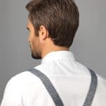 Side view of a man with short brown hair and white shirt.