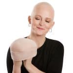 Woman with a bald head wearing a beige soft lift hat from Hidden Secrets Wigs.