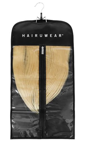 Blonde hair extension in a black travel bag with hanger for wigs and extensions.