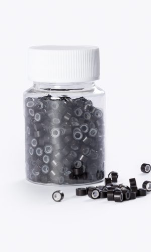 Small silicone micro beads in a clear jar for hair extension installation.