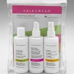 Travel-sized wig care kit with shampoo, conditioner, and styling spray in clear bag.