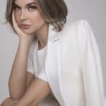 Elegant woman wearing Mira wig from Hidden Secrets Wigs, styled in a chic bob with soft waves.