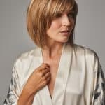 Woman with short, layered blonde wig from Hidden Secrets Wigs.