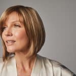 Woman with short, layered blonde wig from Hidden Secrets Wigs.