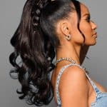 Elegant high ponytail with luxurious curls and claw clip for a stylish look.