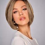Woman with a sleek, shoulder-length bob wig in blonde highlights.