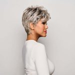 Short silver wig styled on a woman with side profile view.