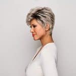 Short gray wavy wig styled on a woman with side profile view.