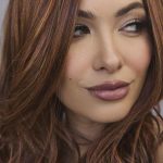 Elegant auburn wig with soft waves for stylish looks.