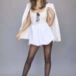 Fashion model wearing Leoni wig from Alexander Couture Collection with stylish outfit.