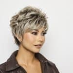 Stylish woman with short, textured blonde wig from Hidden Secrets Wigs.