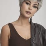 Stylish woman with short silver wig and edgy outfit for fashion look.