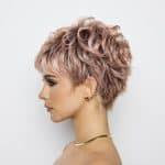 Stylish short curly wig in soft pink shades for a modern look.