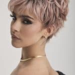 Stylish short pink wig with textured layers for a modern look.