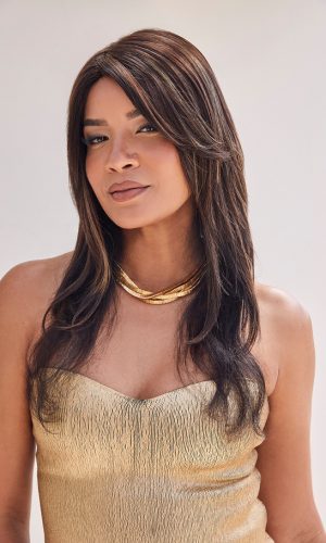Woman wearing a long, layered brown wig with subtle highlights.