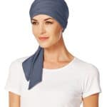 Woman wearing a blue short scarf styled as a head wrap.