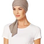 Women wearing a beige Maha Short Scarf with a white top.