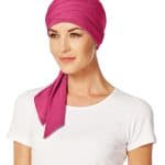 Pink short scarf styled as a head wrap on a woman.