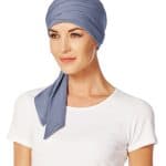 Women wearing a blue short scarf with a white top, stylish head covering.
