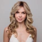 Blonde medium wavy wig with layered curls from Hidden Secrets Wigs.