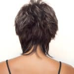 Short, textured wig in dark brown with layered styling.