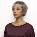 Fashion model wearing a short, silver-gray wig from Hidden Secrets Wigs collection.