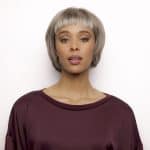 Fashion model with short silver wig in burgundy top for wig showcase.